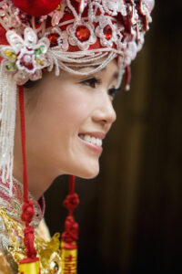 Smiling bride wearing traditional Chinese bridal clothing