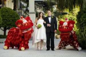 Red Chinese dragons either side of a stunning bride and groom