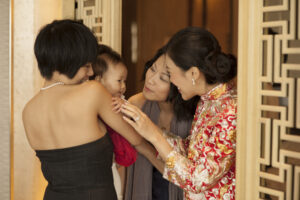 Bride and friends fawning over cute toddler