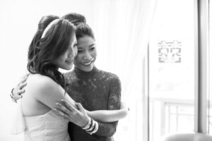 Bride and friend embracing