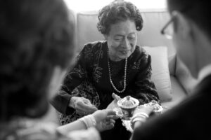 Black and white picture of Grandma receiving tea