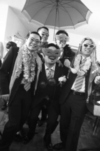 Black and white photo of groomsmen wearing masks