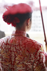 Bride wearing red and gold Chinese wedding attire