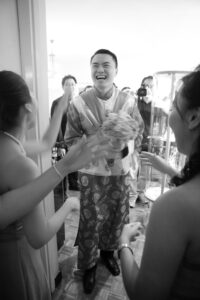 Black and white image of Chinese groom being celebrated by family