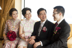 Chinese bride with family sitting and talking by a window