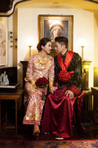 Bride and groom sitting next to each other and gazing into each others eyes