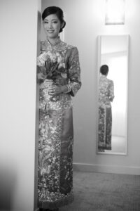 Black and white picture of a beautiful bride waiting to make her entrance holding a bouquet