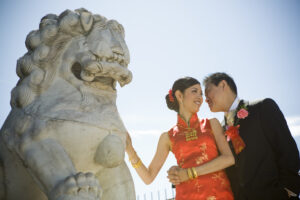 Stone Chinese dragon with bride and groom posing beside it