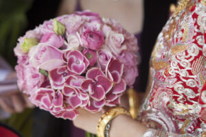 Bride holding a beautiful pink floral round bouquet