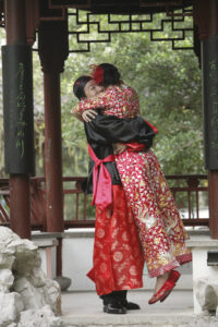 Groom hugging and lifting his new bride off her feet